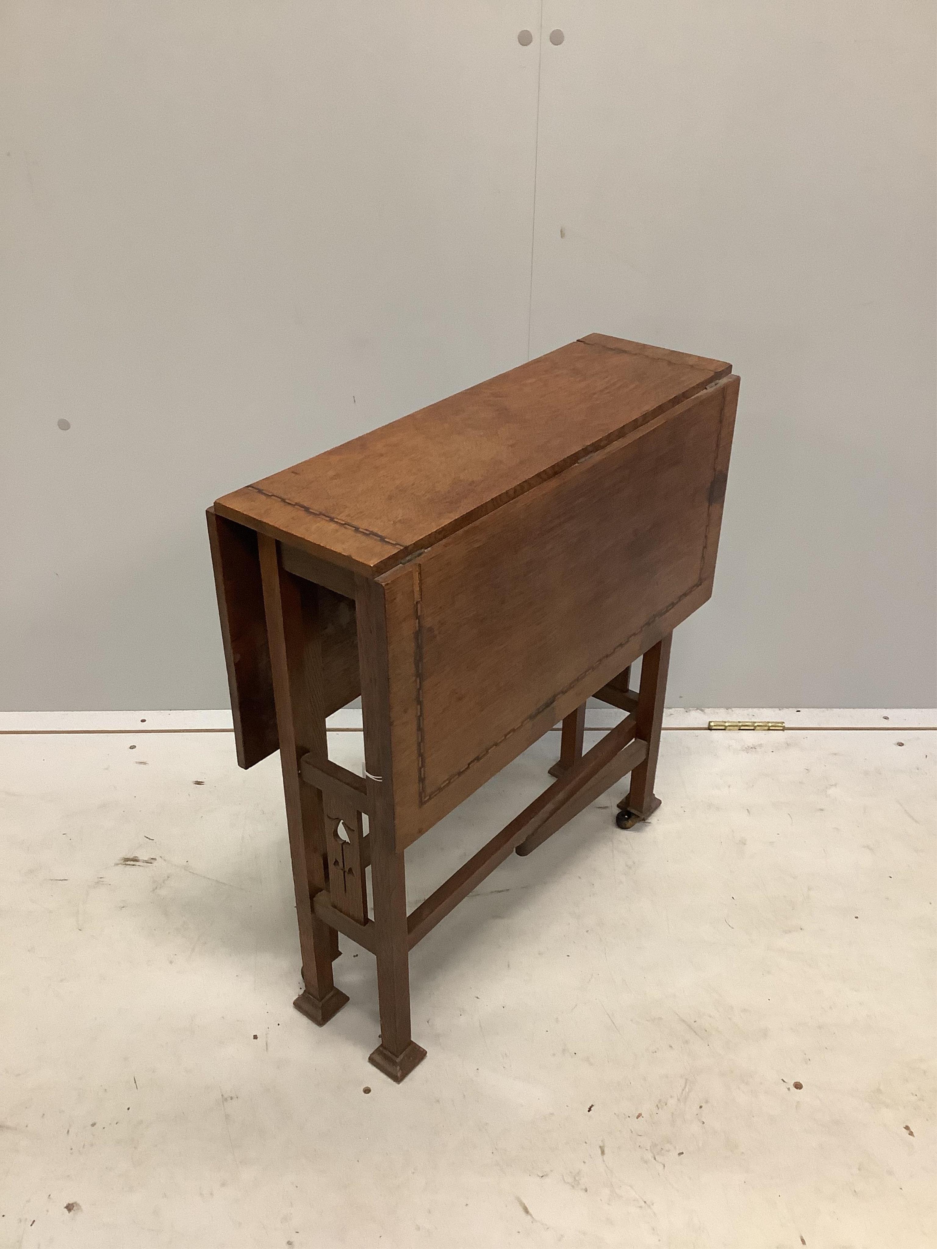 An Arts & Crafts inlaid oak Sutherland table, width 56cm, depth 20cm, height 60cm. Condition - fair